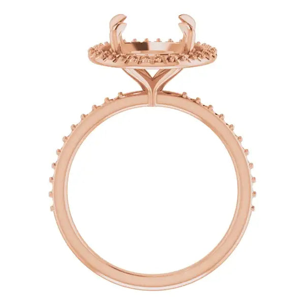 Rose gold engagement ring setting with halo design and pave detailing, shown without center stone.