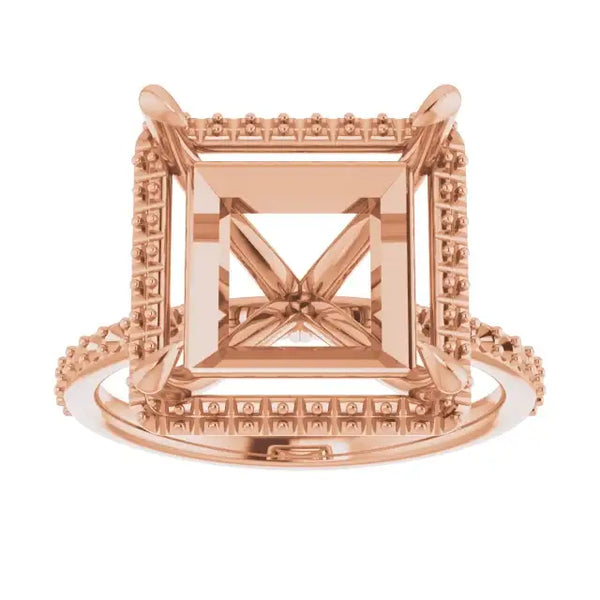 Rose gold halo engagement ring setting with square stone holder and decorative detailing on band and frame.