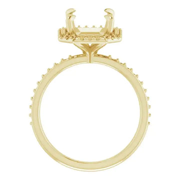 Gold engagement ring setting with halo design and cushion-shaped stone holder surrounded by small accent stones.