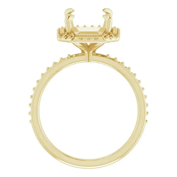 Gold engagement ring setting with halo design and cushion-shaped stone holder surrounded by small accent stones.