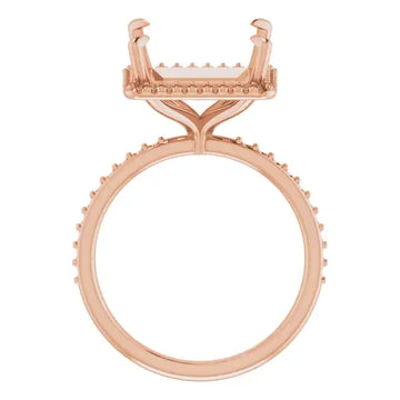Rose gold engagement ring setting with square stone holder and halo diamond accent band.