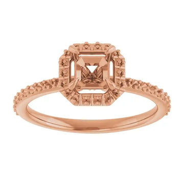 Rose gold halo engagement ring setting with asscher-cut stone center and decorative beaded band.