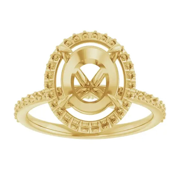 Gold engagement ring setting with oval halo center and textured band.