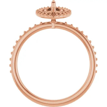 Rose gold engagement ring setting with halo of small round stones and open center for marquise stone placement.