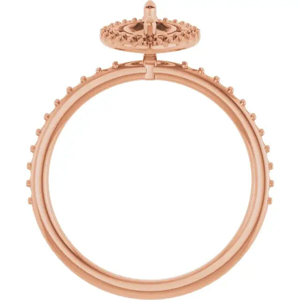 Rose gold engagement ring setting with halo of small round stones and open center for marquise stone placement.