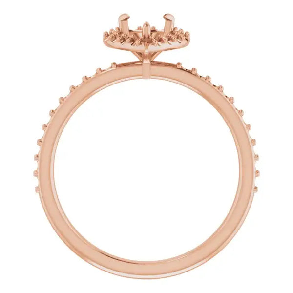 Rose gold engagement ring setting with halo design and accent stones around band.