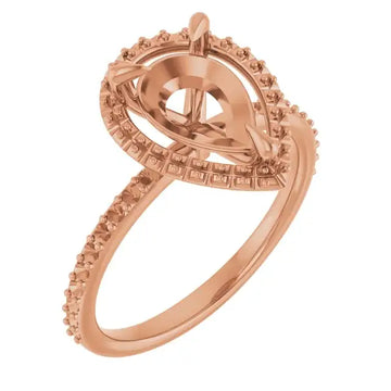 Rose gold engagement ring setting with pear-shaped stone holder surrounded by small square faceted accents on band and halo.