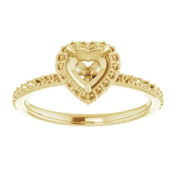 Gold halo engagement ring setting with heart-shaped center stone and diamond-accented band.