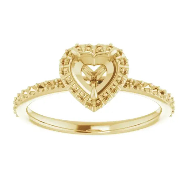 Gold halo engagement ring setting with heart-shaped center stone and diamond-accented band.