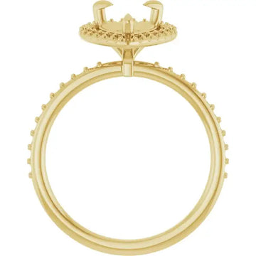 Gold engagement ring setting with halo crown and studded band designed for pear-shaped stones.
