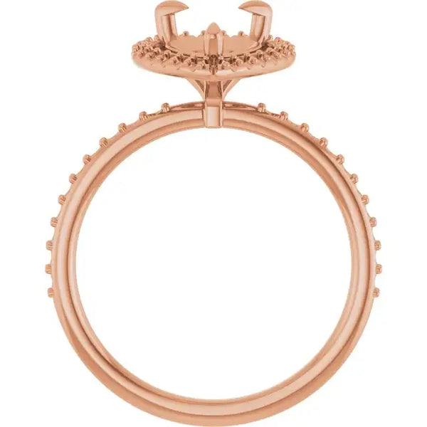 Rose gold engagement ring setting with halo design and small round stone accents around band and top.