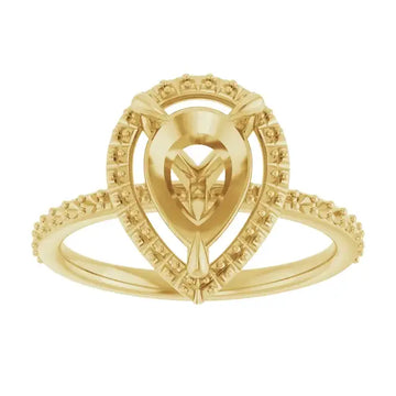 Yellow gold engagement ring setting with pear-shaped center stone and halo of small diamonds.