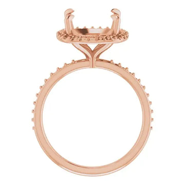 Rose gold ring setting with cushion-cut stone holder featuring halo design and textured band.