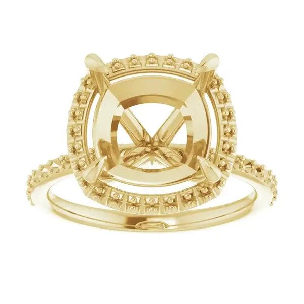 Gold halo engagement ring setting with cushion-cut stone center and diamond-accented band.