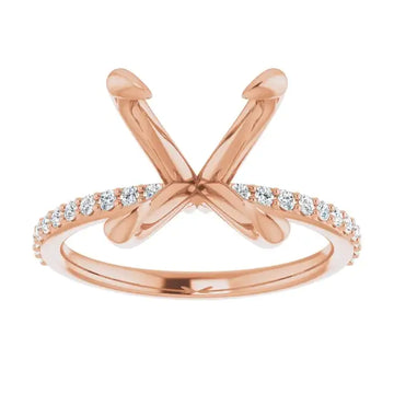 Rose gold engagement ring setting with crossed prongs for oval stones and diamond-accented band.