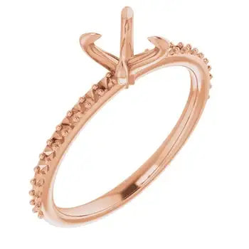 Rose gold engagement ring setting with solitaire prongs and diamond-studded band for round stones.