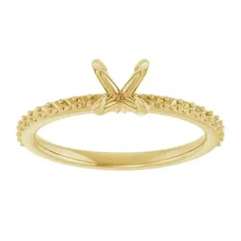 Gold-tone engagement ring setting with textured band and V-shaped prongs for round stone.