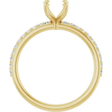 Yellow gold engagement ring setting with diamond accents along the band and split prong head for emerald stone.