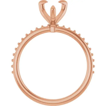 Rose gold engagement ring setting with pear-shaped stone holder and decorative prongs around the band.