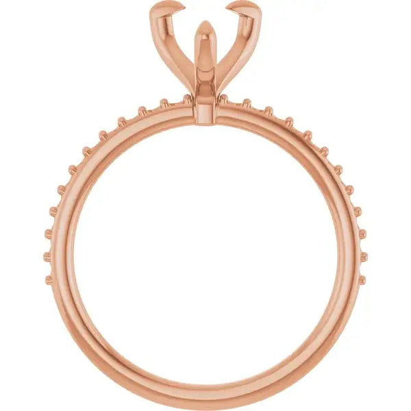 Rose gold engagement ring setting with pear-shaped stone holder and decorative prongs around the band.