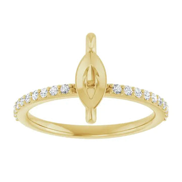 Gold engagement ring with marquise-shaped setting and round diamonds along the band.