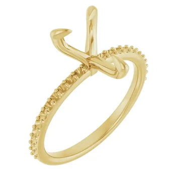 Gold engagement ring setting with pear-shaped stone holder and diamond-accented band.