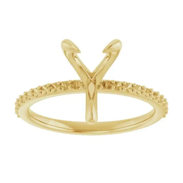Gold engagement ring setting with V-shaped prongs for pear-shaped stones and textured band.