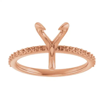 Rose gold engagement ring setting with V-shaped prongs and textured band for pear-shaped stones.