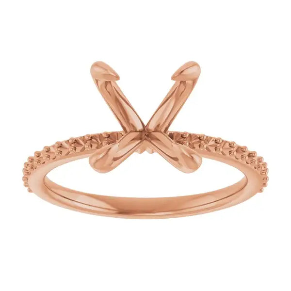 Rose gold engagement ring setting with crossed prongs and textured band for oval stone placement.
