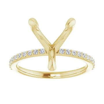 Gold engagement ring setting with V-shaped prongs and round diamonds accenting the band.