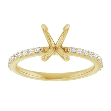 Gold engagement ring setting with X-shaped prongs and diamond-studded band for emerald stone.