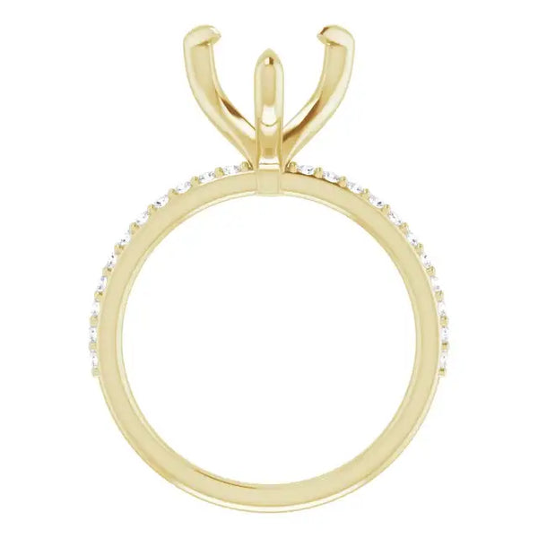 Gold engagement ring setting with V-shaped prongs and diamond accents along the band.