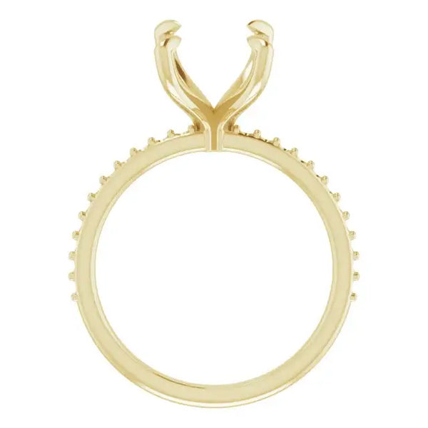 Yellow gold engagement ring setting with decorative prongs around band and split fork-shaped head for emerald stone placement