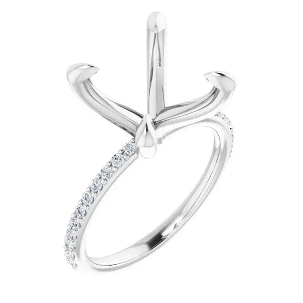White metal engagement ring setting with four-prong head and diamond-accented band.