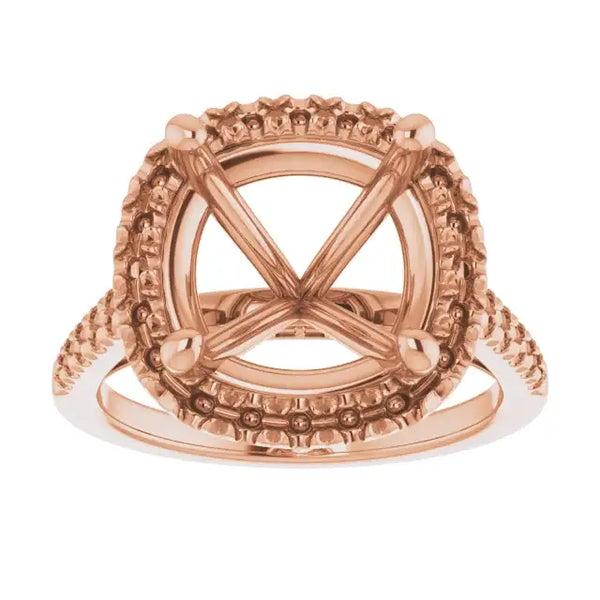 Rose gold engagement ring setting with ornate detailing and cushion stone seat, viewed from front.