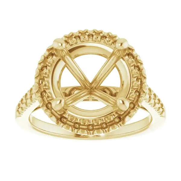 Gold engagement ring setting with ornate halo and accents surrounding empty round stone center.