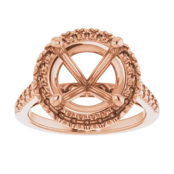 Rose gold ring setting with ornate halo and accented band for round stone.
