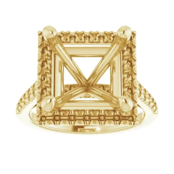 Gold engagement ring setting with square stone holder, decorative border detailing, and accent stones at corners.