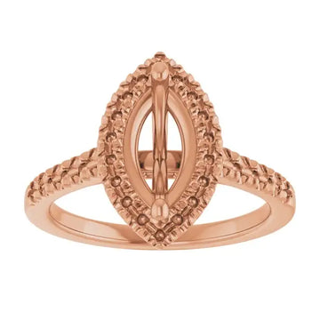 Rose gold engagement ring setting with ornate marquise-shaped center stone frame and textured accented shoulders.
