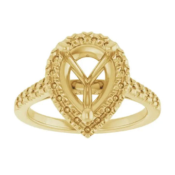 Gold engagement ring setting with ornate pear-shaped stone mount and textured band accents.