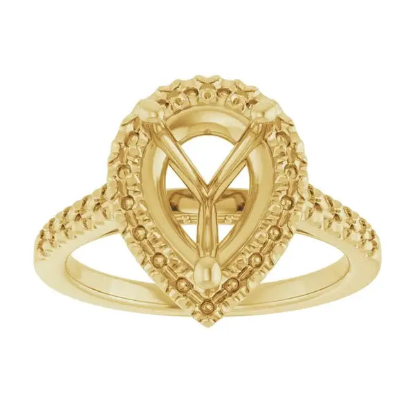 Gold engagement ring setting with ornate pear-shaped stone mount and textured band accents.
