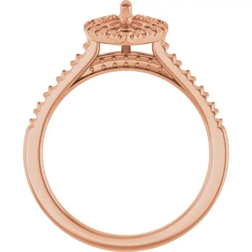 Rose gold engagement ring setting with decorative halo and accent stones along the band.