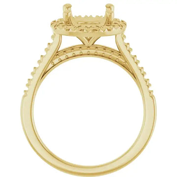 Gold engagement ring setting with ornate shoulders, decorative gallery rail, and oval stone mounting with accent stones.