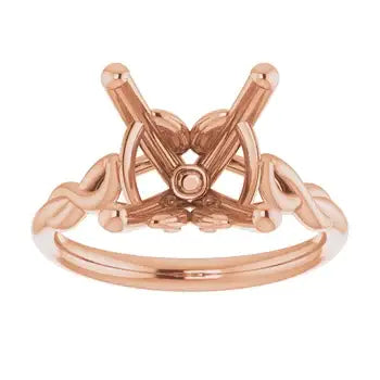 Rose gold solitaire engagement ring setting with cushion stone head and decorative curved shoulders.