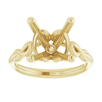 Gold solitaire engagement ring setting with crossed prongs and decorative band, designed for cushion-cut stones.