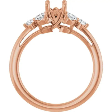 Rose gold engagement ring setting with open prongs for round stone and two accent diamonds on shoulders.