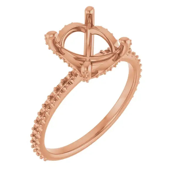 Rose gold engagement ring setting with halo design and oval stone mounting, featuring pavé band details.