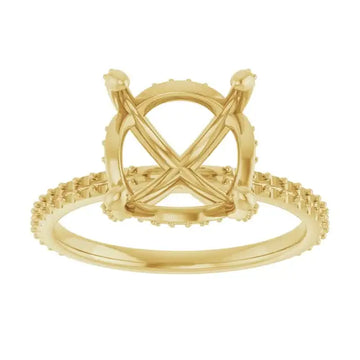 Gold ring setting with crossover band, textured halo design, and vacant round stone mount.