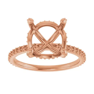 Rose gold engagement ring setting with crossed prongs, halo design, and textured band for round stones.