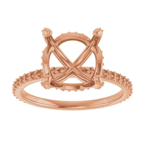 Rose gold engagement ring setting with crossed prongs, halo design, and textured band for round stones.